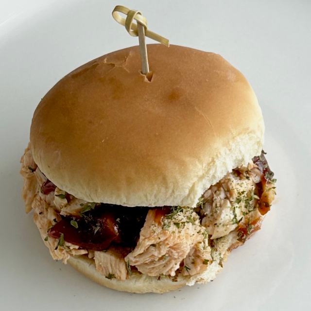 A chopped barbecue chicken slider on a soft bun