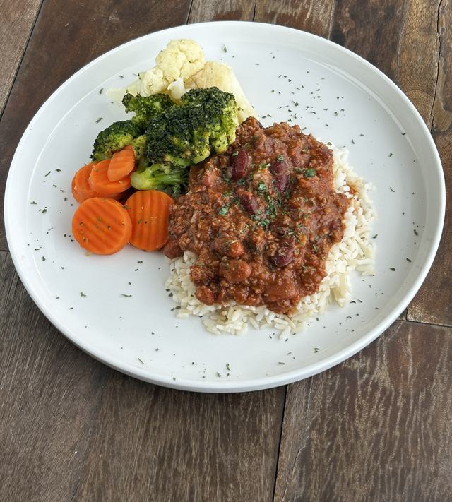 Beef and bean chili over white rice with carrots, broccoli and cauliflower
