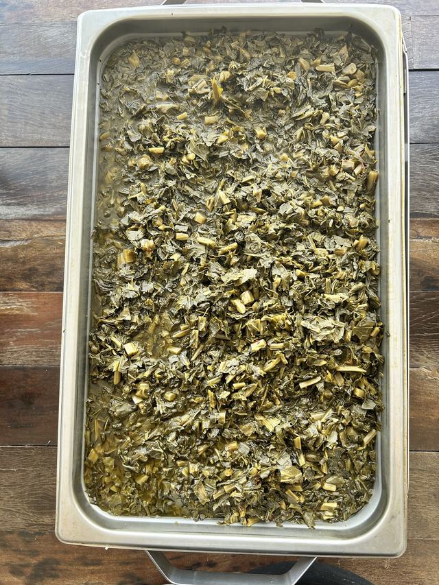 A full pan of slow cooked Southern collard greens