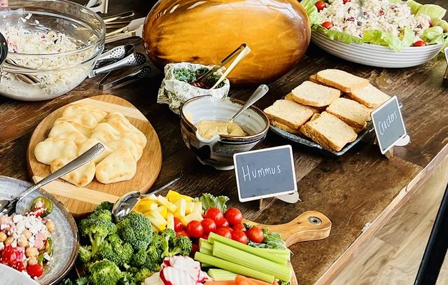 Hummus, crackers and chicken salad on a catered party table